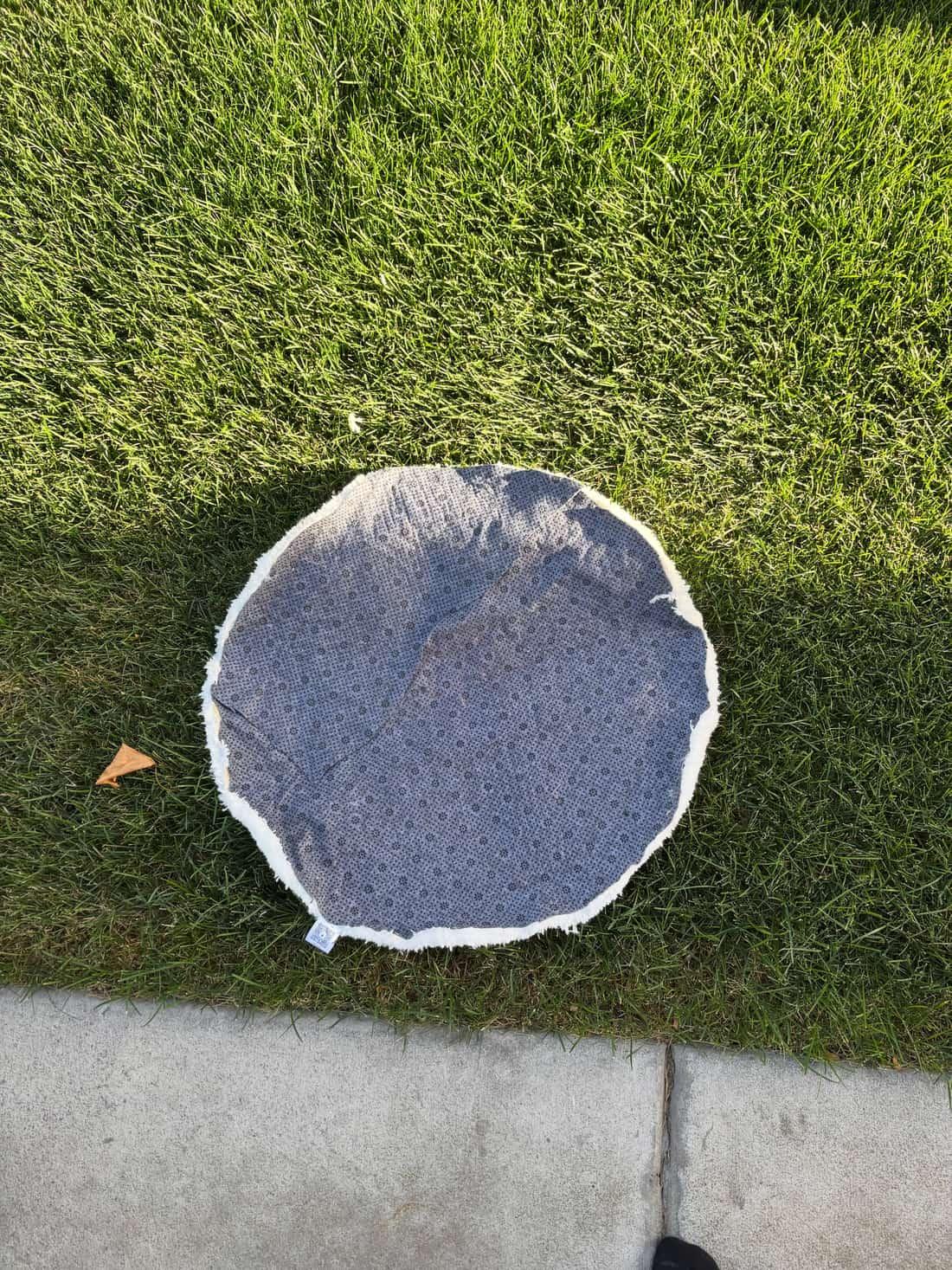 The back of the rug, showing the grey non-slip backing and bound edge