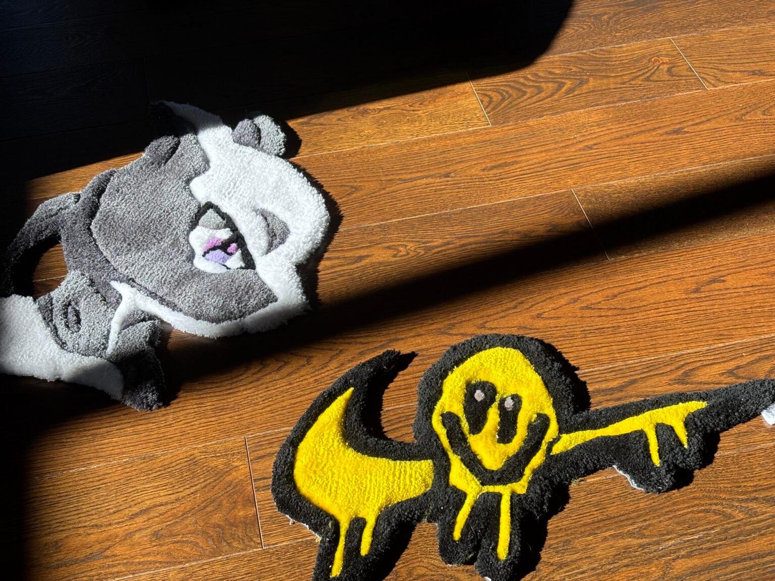 Two finished hand-tufted rugs on a wood floor